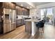 Bright kitchen with stainless steel appliances, granite countertops, and dark wood cabinets at 1525 W 68Th Ave, Denver, CO 80221