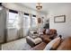 Comfortable living room featuring leather furniture, lots of natural light, and modern decor at 1525 W 68Th Ave, Denver, CO 80221