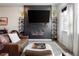 Beautiful living room with a fireplace, modern decor, and comfortable leather furniture at 1525 W 68Th Ave, Denver, CO 80221