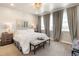 Serene primary bedroom featuring soft lighting, neutral colors, and large windows at 1525 W 68Th Ave, Denver, CO 80221