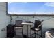 Cozy rooftop deck featuring stylish chairs and table, with a stunning cityscape in the distance at 1525 W 68Th Ave, Denver, CO 80221