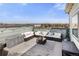Relaxing rooftop deck with comfortable seating, stylish rug, and panoramic city views at 1525 W 68Th Ave, Denver, CO 80221