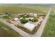 Aerial view showcases the property's boundaries, surrounding fields, and multiple structures on the land at 20995 County Road 28, Hudson, CO 80642