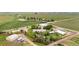 Aerial view outlines the property with its various buildings, road access, and neighboring agricultural land at 20995 County Road 28, Hudson, CO 80642