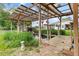 Outdoor pond with waterfall feature and covered wooden pergola at 20995 County Road 28, Hudson, CO 80642