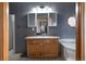 Bathroom with a white sink, vanity, and a three-panel mirror above the sink with light fixture at 20995 County Road 28, Hudson, CO 80642