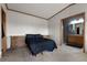 A comfortable bedroom shows a bed and side tables along with an open entrance to the bathroom at 20995 County Road 28, Hudson, CO 80642