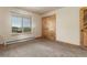 Bedroom with large window, carpet and doors with wooden frames at 20995 County Road 28, Hudson, CO 80642