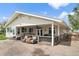 Covered patio area furnished with comfortable seating, perfect for outdoor relaxation and entertaining at 20995 County Road 28, Hudson, CO 80642