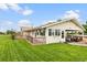 Ranch-style home boasts an attached carport and well-kept lawn, providing a welcoming curb appeal at 20995 County Road 28, Hudson, CO 80642