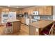 Bright kitchen featuring custom wood cabinetry, hardwood floors, and an island at 20995 County Road 28, Hudson, CO 80642