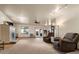 Spacious living room featuring plush armchairs, a ceiling fan, and a fireplace for cozy comfort at 20995 County Road 28, Hudson, CO 80642
