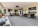 Covered outdoor patio features ample seating and a ceiling fan for a comfortable space at 20995 County Road 28, Hudson, CO 80642