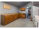 A gray room with wood counter, cabinets, and light gray walls with blue speckled floor and a shelf in the corner at 20995 County Road 28, Hudson, CO 80642
