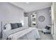 Serene bedroom features soft carpet, a cozy bed with stylish gray bedding, and a decorative accent chair at 248 S 5Th Ave, Brighton, CO 80601