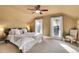 Bedroom with neutral tones, carpeted floor, ceiling fan, and bright natural light from the two windows at 248 S 5Th Ave, Brighton, CO 80601