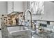 Close-up of a kitchen sink with modern faucet and sleek countertop at 248 S 5Th Ave, Brighton, CO 80601