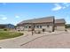 A large backyard featuring a stamped concrete walkway and patio, landscaped beds, and a lush lawn at 4714 Carmichael Ct, Brighton, CO 80603