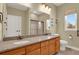 Spacious bathroom featuring double sinks with granite counters and access to a walk-in shower at 4714 Carmichael Ct, Brighton, CO 80603