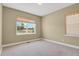 Bedroom featuring neutral carpet, paint, and two windows providing natural light and views at 4714 Carmichael Ct, Brighton, CO 80603
