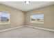 Bedroom with two windows offering neighborhood views and natural light at 4714 Carmichael Ct, Brighton, CO 80603