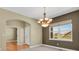 Elegant dining area with chandelier, large window, and easy access to other rooms at 4714 Carmichael Ct, Brighton, CO 80603