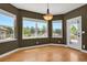 Bright dining area with large windows offering scenic views and access to the outdoor patio at 4714 Carmichael Ct, Brighton, CO 80603