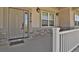 Close-up of front door and porch with stone accent, house numbers and exterior lighting at 4714 Carmichael Ct, Brighton, CO 80603