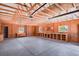 Large, unfinished garage featuring an open layout, exposed ceiling rafters, shelving, and ample workspace at 4714 Carmichael Ct, Brighton, CO 80603