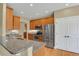 Modern kitchen featuring granite countertops, stainless steel appliances, and ample cabinet space at 4714 Carmichael Ct, Brighton, CO 80603