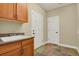 Laundry room with sink, cabinets, and tile flooring at 4714 Carmichael Ct, Brighton, CO 80603