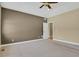 Expansive carpeted main bedroom featuring neutral paint, a vaulted ceiling, and entry to an adjoining room at 4714 Carmichael Ct, Brighton, CO 80603