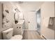 Bathroom featuring a sleek white vanity with black hardware and a toilet at 14602 E 2Nd Ave # 200C, Aurora, CO 80011
