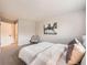 Bright bedroom featuring neutral walls, carpet, modern art and a comfortable chair at 14602 E 2Nd Ave # 200C, Aurora, CO 80011