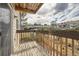 A private deck with sturdy wood railings provides a scenic spot for relaxation overlooking the backyard at 14602 E 2Nd Ave # 200C, Aurora, CO 80011