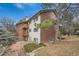 Multi-level condo featuring brick accents, wooden balconies, and mature trees around the property at 14602 E 2Nd Ave # 200C, Aurora, CO 80011