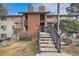 Multi-level condo featuring brick accents, wooden balconies, and stairs leading to upper units at 14602 E 2Nd Ave # 200C, Aurora, CO 80011