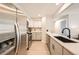 Modern kitchen featuring white cabinets, stainless steel appliances, and sleek countertops at 14602 E 2Nd Ave # 200C, Aurora, CO 80011