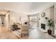 Bright living room featuring a fireplace, sliding glass doors to the outside, and neutral decor at 14602 E 2Nd Ave # 200C, Aurora, CO 80011