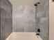 Modern tub to shower conversion features grey tiled walls and black fixtures at 14602 E 2Nd Ave # 200C, Aurora, CO 80011