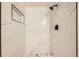 Close-up of a modern tiled shower with a rainfall showerhead and sleek black fixtures at 14602 E 2Nd Ave # 200C, Aurora, CO 80011