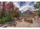 Charming backyard featuring raised garden beds, gravel pathways, and a storage shed at 3201 S Pearl St, Englewood, CO 80113