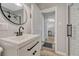 Bathroom featuring a modern vanity with black hardware, grey walls, subway tile, and white trim at 3201 S Pearl St, Englewood, CO 80113
