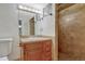 Bathroom featuring tile floors, a wood vanity with drawers, mirror and a walk-in shower at 3201 S Pearl St, Englewood, CO 80113