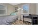 Bright bedroom featuring a twin bed, desk, and a window with natural light at 3201 S Pearl St, Englewood, CO 80113