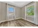 Bright bedroom with wood floors and two windows offering natural light and neighborhood views at 3201 S Pearl St, Englewood, CO 80113