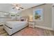 This bedroom features an area rug, wood floors, a ceiling fan and a queen bed at 3201 S Pearl St, Englewood, CO 80113