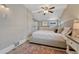 This bedroom features an area rug, wood floors, a ceiling fan and a queen bed at 3201 S Pearl St, Englewood, CO 80113