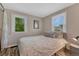 Comfortable bedroom featuring a queen bed, two windows with tree view, and ample natural light at 3201 S Pearl St, Englewood, CO 80113