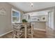 Dining area with a table and chairs, adjacent to kitchen and a window at 3201 S Pearl St, Englewood, CO 80113